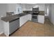 Kitchen featuring stainless steel appliances and white cabinetry at 7440 Kildare St, New Port Richey, FL 34653