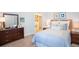 Cozy bedroom with carpet flooring, two windows, and coastal-themed decorations at 25408 Jubal St, Punta Gorda, FL 33955