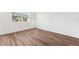 A bright bedroom with wood floors and a window provides a relaxing retreat at 6160 Pina Colada St, Zephyrhills, FL 33542