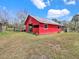 Red barn with rustic charm, offering ample storage and a touch of countryside allure at 8123 Double Branch Rd # 1, Tampa, FL 33635