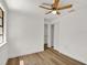 Bright bedroom featuring wood floors, a ceiling fan, and a closet at 8123 Double Branch Rd # 1, Tampa, FL 33635