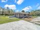Cozy single-story home featuring a covered porch, nestled on a spacious lot with lush green grass at 8123 Double Branch Rd # 1, Tampa, FL 33635