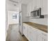 Bright kitchen with white cabinets, wood countertop, and stainless steel appliances at 8123 Double Branch Rd # 1, Tampa, FL 33635