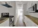 Galley kitchen with white cabinets, wood countertop, and stainless steel appliances at 8123 Double Branch Rd # 1, Tampa, FL 33635