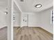Bright living room featuring light wood floors, white walls, and modern lighting at 8123 Double Branch Rd # 1, Tampa, FL 33635