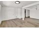 Open-concept living area with wood-look flooring, white walls, and recessed lighting, creating a modern and versatile space at 8123 Double Branch Rd # 1, Tampa, FL 33635