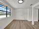 Bright, open room with wood-look flooring, white walls, and a large window offering natural light and outdoor views at 8123 Double Branch Rd # 1, Tampa, FL 33635