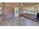 Charming screened porch with wood-look flooring and ample natural light, perfect for relaxing or entertaining guests at 8123 Double Branch Rd # 1, Tampa, FL 33635