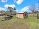 A wooden shed on a spacious property provides storage, workshop potential, and room for hobbies at 8123 Double Branch Rd # 1, Tampa, FL 33635