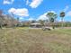 Expansive yard with a home and rustic wood pile, perfect for relaxing outdoors at 8123 Double Branch Rd # 1, Tampa, FL 33635