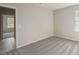 Bedroom boasts neutral walls, gray carpeting, a window for natural light, and an open doorway at 16449 Campo Sano Ct, Punta Gorda, FL 33955