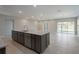 Kitchen island featuring a granite countertop, sink, dishwasher, and gray cabinets in an open floor plan at 16449 Campo Sano Ct, Punta Gorda, FL 33955