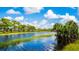 Scenic water view featuring a blue waterway surrounded by lush greenery and a clear blue sky at 16449 Campo Sano Ct, Punta Gorda, FL 33955