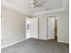 A light and airy bedroom featuring neutral paint, ceiling fan, and doorway to another room at 2481 Sagemont Dr, Brandon, FL 33511