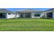 This backyard boasts a green lawn and a view of the home's rear exterior at 4914 Carova Way, Lakewood Ranch, FL 34211