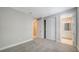 Spacious bedroom with neutral walls and carpet adjacent to bathroom and closet at 4914 Carova Way, Lakewood Ranch, FL 34211
