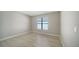 The bedroom offers light hardwood floors and a window with bright, natural light at 4914 Carova Way, Lakewood Ranch, FL 34211