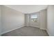 This bedroom has neutral carpet, a window with blinds, and painted walls at 4914 Carova Way, Lakewood Ranch, FL 34211
