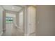Bright hallway featuring hard surface flooring, modern door, and trim at 4914 Carova Way, Lakewood Ranch, FL 34211