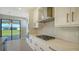 Well-lit kitchen showcases stainless steel appliances, white cabinets and opens to backyard patio at 4914 Carova Way, Lakewood Ranch, FL 34211