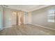 This main bedroom has light hardwood floors, tray ceiling, and access to the bathroom at 4914 Carova Way, Lakewood Ranch, FL 34211