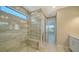 Bathroom shower with glass surround, built-in bench, and window for natural light at 4914 Carova Way, Lakewood Ranch, FL 34211
