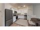 Well-equipped kitchen featuring stainless steel appliances, granite countertops, and white cabinets at 6152 Pina Colada St, Zephyrhills, FL 33542