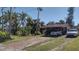 Charming home with covered parking, mature trees, and a well-maintained lawn at 6317 Fairway Blvd, Apollo Beach, FL 33572