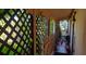 A covered porch with decorative latticework and views of tropical greenery at 6317 Fairway Blvd, Apollo Beach, FL 33572