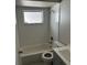 A bathroom with white tiled walls, vanity, and matching flooring at 6405 Gainsboro Dr, Port Richey, FL 34668