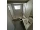 A bathroom with white tiled walls, vanity, and matching flooring at 6405 Gainsboro Dr, Port Richey, FL 34668