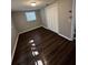 A bedroom featuring dark wood flooring and a double door closet at 6405 Gainsboro Dr, Port Richey, FL 34668