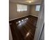 A bedroom featuring dark wood floors, natural light from two windows and a neutral paint at 6405 Gainsboro Dr, Port Richey, FL 34668