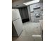 Bright kitchen with modern appliances, white cabinetry, and tile floors at 6405 Gainsboro Dr, Port Richey, FL 34668