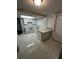 Updated kitchen featuring white cabinets, modern countertops, and a skylight at 6405 Gainsboro Dr, Port Richey, FL 34668