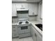 Well-lit kitchen featuring a new range and a convenient sink area at 6405 Gainsboro Dr, Port Richey, FL 34668