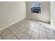 Bright, airy bedroom with neutral walls and tile flooring, illuminated by natural light at 8326 Iberia Pl, Tampa, FL 33637