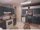 Functional kitchen featuring tiled floors and matching cabinetry with ample counter space at 2632 Wrencrest Cir, Valrico, FL 33596