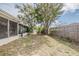 Expansive backyard with a partial fence, leading to a screened-in porch, ideal for outdoor enjoyment and relaxation at 9811 Rainbow Ln, Port Richey, FL 34668