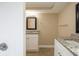 This updated bathroom features dual granite vanities, tile flooring, and a tub at 9811 Rainbow Ln, Port Richey, FL 34668