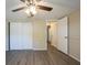 This cozy bedroom features a ceiling fan and a closet with white doors at 9811 Rainbow Ln, Port Richey, FL 34668