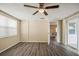 Bedroom with wood flooring and sliding glass door leading to the screened porch at 9811 Rainbow Ln, Port Richey, FL 34668
