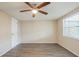 This bright bedroom has a ceiling fan and lots of natural light from the window at 9811 Rainbow Ln, Port Richey, FL 34668
