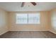 This bedroom has neutral paint and great light from the large window at 9811 Rainbow Ln, Port Richey, FL 34668