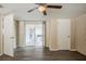 Bedroom features wood flooring, ceiling fan, and sliding doors leading to screened porch at 9811 Rainbow Ln, Port Richey, FL 34668