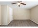Bedroom with wood flooring, brick accent wall, and ceiling fan at 9811 Rainbow Ln, Port Richey, FL 34668