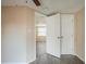The door to this bedroom is open to another room with natural light at 9811 Rainbow Ln, Port Richey, FL 34668