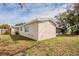 Home exterior with a well-maintained lawn, neutral paint, and functional windows, providing a clean and welcoming appearance at 9811 Rainbow Ln, Port Richey, FL 34668