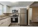 Bright kitchen with stainless steel appliances, granite countertops, and new cabinets at 9811 Rainbow Ln, Port Richey, FL 34668