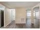 Open-concept living room with gray wood flooring and neutral paint tones throughout at 9811 Rainbow Ln, Port Richey, FL 34668